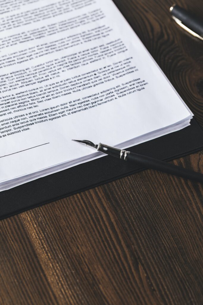 juridical contract on wooden table with pen, law concept